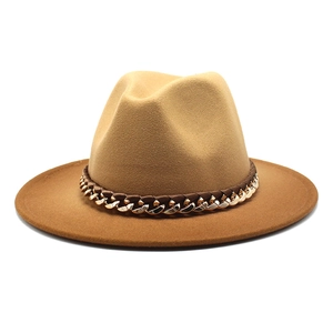 Detailed shot of two-tone wool jazz hat with brown leather band and gold metal chain