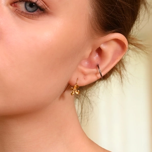 Elegant 18K gold plated flower hook earrings and silver hoop worn on a model