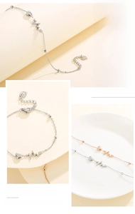 Detail showing heartbeat line with heart pendant on stainless steel chain bracelet