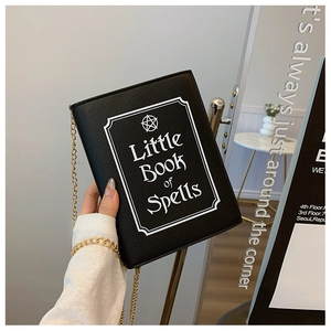 Detail of book-shaped black crossbody bag with Little Book of Spells star print