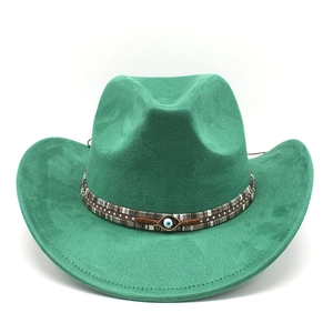 Close-up of green felt cowboy hat featuring a blue evil eye emblem on woven band
