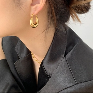 Pendientes de aro gruesos dorados en forma de U con un collar de cadena de oro a juego