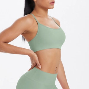 Détail du soutien-gorge de yoga vert sauge avec fines bretelles et legging sans couture