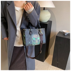 Detail of skull print tote bag with green lightning pattern and wide FASHION shoulder strap