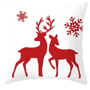 Close-up of a white Christmas pillowcase with two red reindeer and snowflake patterns