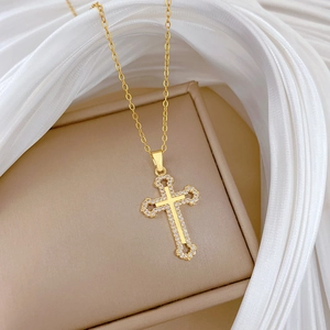 Detailed macro view of a gold double-layer hollow cross pendant set with sparkling zircons