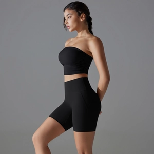 Side view of a black high-stretch seamless yoga set featuring crop top and gym shorts