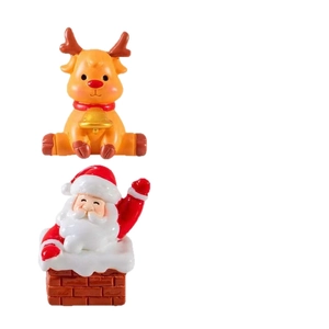 Miniature resin Christmas figurines featuring a reindeer and Santa in a red chimney