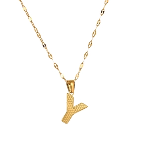 Close-up of golden letter Y pendant with honeycomb texture and fine chain necklace