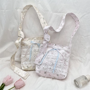 Detailed view of floral lace crossbody bags with silk texture and cute ribbon bows