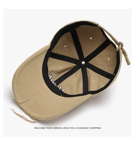 Detail view of khaki baseball cap interior with reinforced seams and adjustable metal buckle