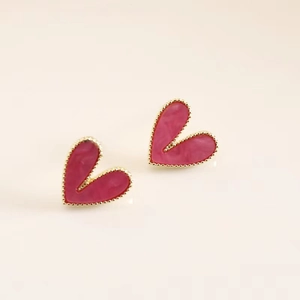 Detailed view of rose pink heart stud earrings with golden beaded edges and glossy finish