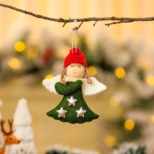 Detail of Christmas angel doll ornament hanging on tree branch with festive warm lighting