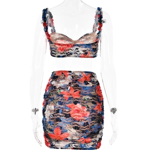 Detailed view of women's two-piece lace set with red and blue floral print design