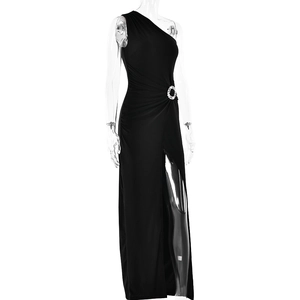 Detailed view of single shoulder black evening gown featuring a round rhinestone waist buckle