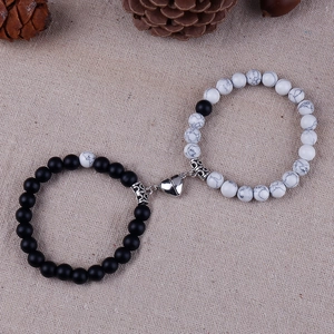Close-up of matte black and white marble stone bracelets with heart-shaped magnetic clasp