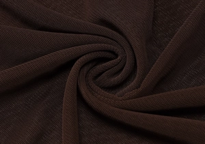 Detailed macro view of brown mesh fabric texture with elegant pleated spiral folding