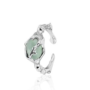 Detailed macro view of 925 silver irregular branch ring with light green oval gemstone