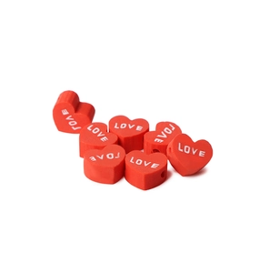 Close-up of heart-shaped red clay beads with white LOVE lettering for DIY jewelry