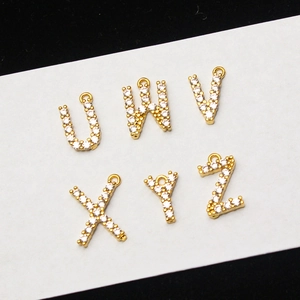 Macro shot of gold-plated letter charms U to Z with pavé micro-inlaid zircon crystals