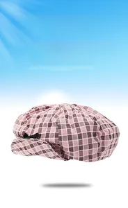 Detail of pink and brown checkered beret with a decorative black bow for women