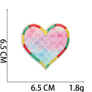 Close-up of heart-shaped mermaid embroidery patch with gradient scales and glitter texture
