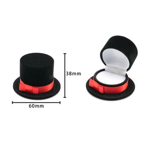 Detail view of tuxedo hat jewelry box with red ribbon showing open and closed dimensions