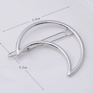 Detailed view of silver crescent moon hair clip showing 5.6cm by 5.2cm size dimensions