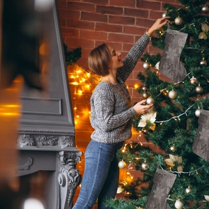 Hanging charcoal gray Christmas stockings with white snowflake embroidery on a tree