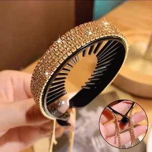 Close-up of sparkling gold rhinestone hair claw clip with elegant tassel fringe detail