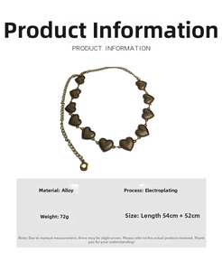 Macro view showing vintage gold heart charms and detailed floral engraving on metal waist chain