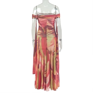 Detail of printed maxi dress with back ruching on transparent mannequin display