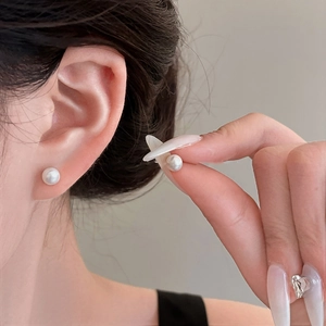 Elegant 925 silver needle freshwater pearl stud earrings on model's ear, 8mm minimalist design