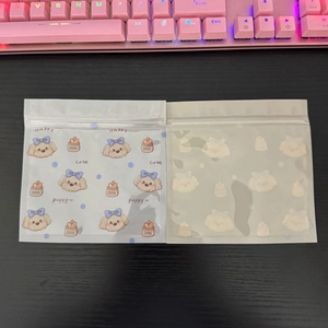 Close-up of cute cartoon puppy ziplock bags with happy dog patterns for snacks and hair clips