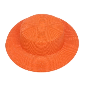 Detailed top view of the woven texture on a bright orange flat top straw sun hat