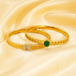Luxury gold plated zircon bracelets set with green gemstone on champagne silk background