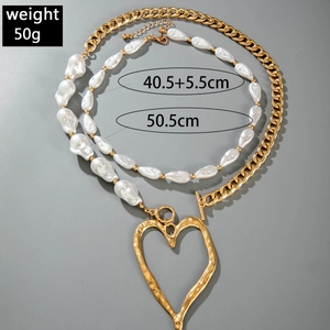 Detail view of double-layer necklace with gold heart pendant and pearl chain dimensions