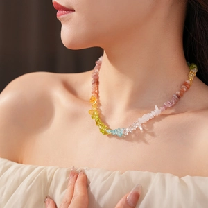Close-up of colorful natural crystal stone beaded necklace on model for summer beach style