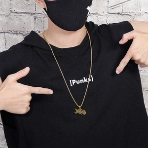Hip hop dumbbell pendant in gold finish worn by a male model with street style aesthetic