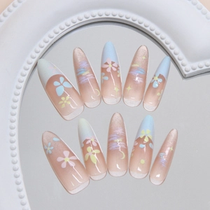 Handmade almond press-on nails with candy floral doodles and pearly cat eye effect