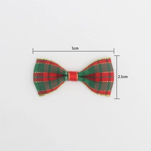 Macro shot of 5x2.5cm red and green plaid Christmas bow with gold thread details