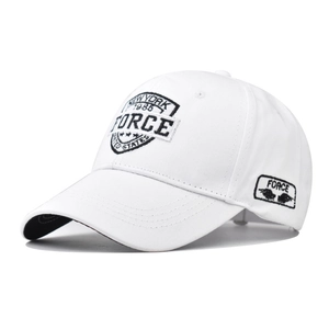 Close-up of FORCE wing embroidery and black piped brim on white cotton baseball cap
