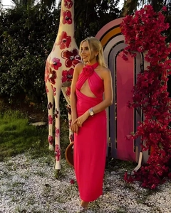 Detail of rose red halter neck maxi dress with front cutout and backless design on model
