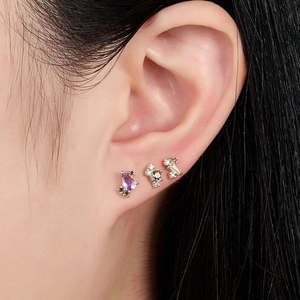 Detailed view of S925 sterling silver studs with purple and champagne cubic zirconia
