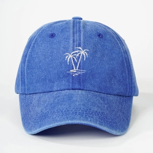 Blue washed denim baseball cap with white embroidered palm trees logo on a white background