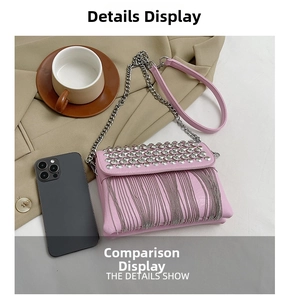 Detail showing pink fringe crossbody bag size comparison with a smartphone on a desk