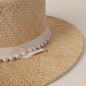 Flat top straw hat with elegant ribbon and pearl chain decoration for women