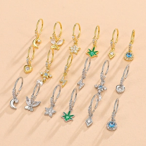 Golden and silver nose rings set with cubic zirconia heart, moon, and star pendants