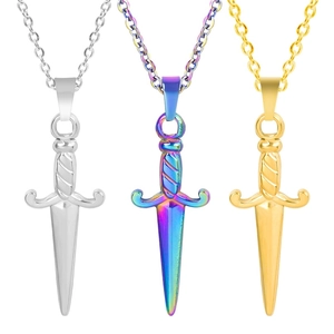 Three dagger sword pendants in silver, rainbow, and 18k gold plating on white background