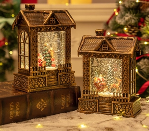 Close-up of vintage bronze Christmas house lanterns with warm LED light and snow scene